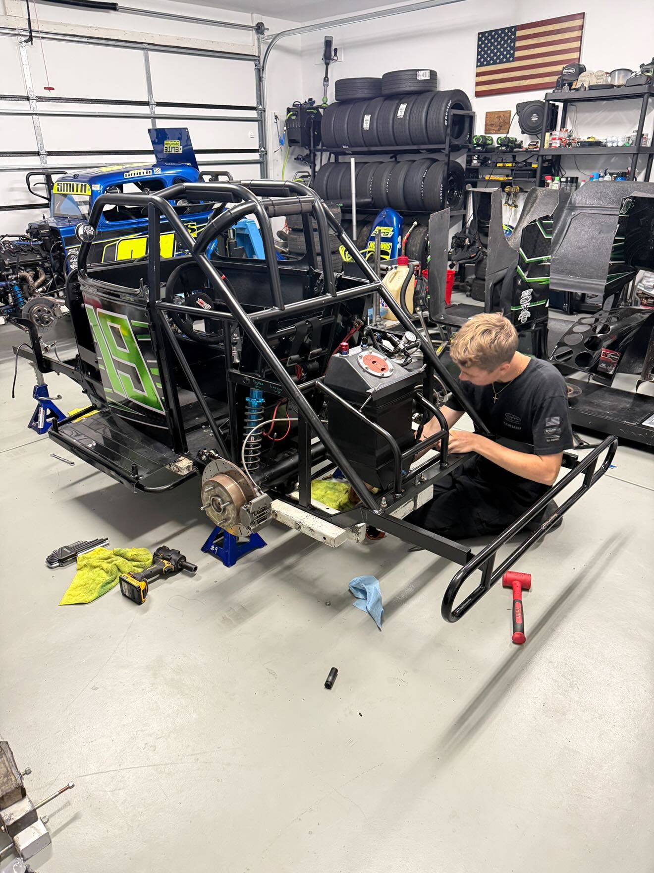 Joel working on a race car in the garage