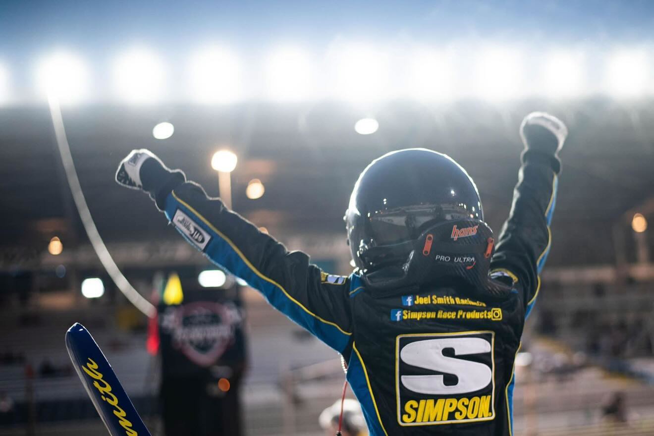 Joel Smith celebrating a victory under stadium lights
